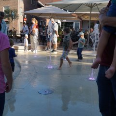 Kinder spielen mit den großen Wasserfontänen am neuen Franziskanerplatz