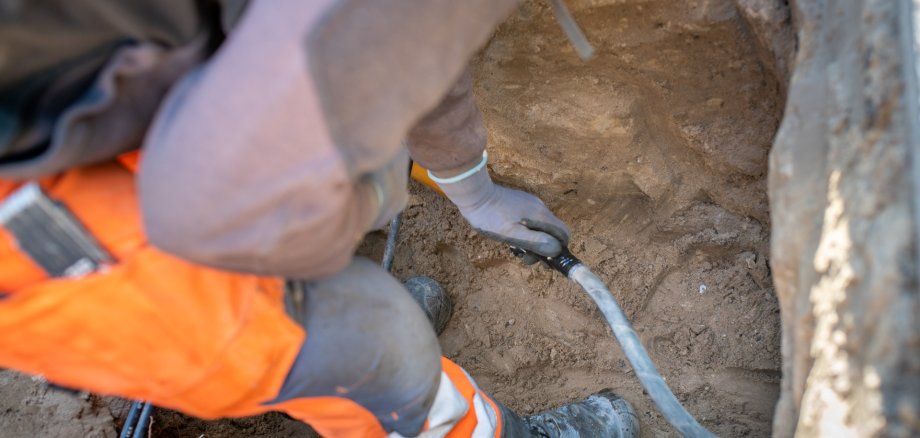 Arbeiter verlegt Anschluss für Gas, Gas Kabel für Hausanschluss
