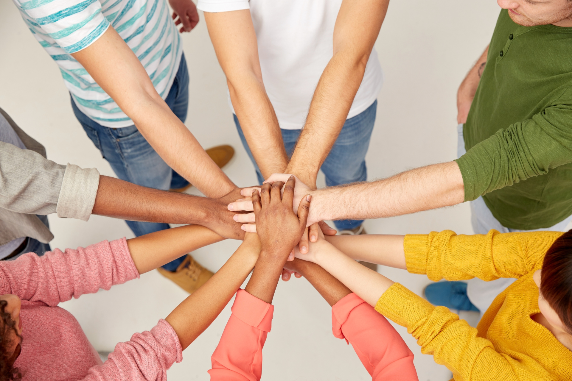 group of international people with hands together group of international people with hands together