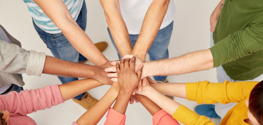 group of international people with hands together group of international people with hands together